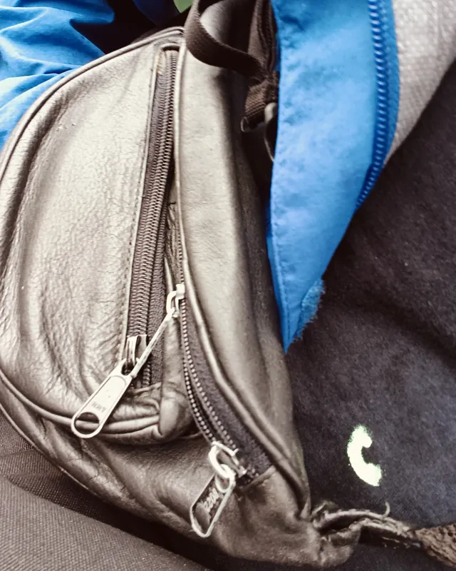A leather bag with a repaired zip