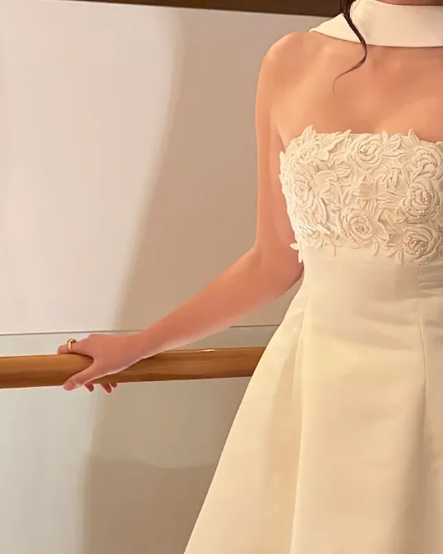 A strapless mini dress with a lace bodice, made from a wedding gown